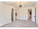 Basement bedroom with carpet, multiple doors, and a chandelier at 5820 Powell Rd, Parker, CO 80134