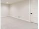 Spacious basement bedroom with plush carpeting and an exterior door at 5820 Powell Rd, Parker, CO 80134