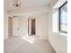 Bright basement bedroom with large window and access to hallway at 5820 Powell Rd, Parker, CO 80134