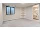 Spacious basement bedroom with built-in shelving and ensuite bathroom at 5820 Powell Rd, Parker, CO 80134