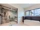 Modern bathroom featuring a glass enclosed shower and a soaking tub at 5820 Powell Rd, Parker, CO 80134