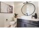 Stylish bathroom with a modern vanity, large mirror, and a toilet at 5820 Powell Rd, Parker, CO 80134
