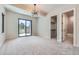 Bright bedroom features modern lighting, neutral decor, and walkout access to the outdoor living area at 5820 Powell Rd, Parker, CO 80134