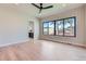 Spacious bedroom with natural light, hardwood floors, and a ceiling fan at 5820 Powell Rd, Parker, CO 80134