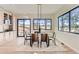 Modern dining room with glass table, built-in cabinetry, and hardwood floors at 5820 Powell Rd, Parker, CO 80134