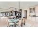 Open concept dining area adjacent to kitchen, featuring a glass dining table at 5820 Powell Rd, Parker, CO 80134