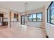 Bright dining room with built-in cabinets, hardwood floors, modern light fixture, and oversized windows at 5820 Powell Rd, Parker, CO 80134