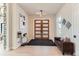 Bright entryway with hardwood floors and a modern glass-top console table at 5820 Powell Rd, Parker, CO 80134