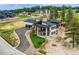 Stunning two-story home with a modern design, sleek black roof, and manicured front lawn at 5820 Powell Rd, Parker, CO 80134