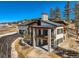 Striking two-story home showcasing stone pillars, a balcony, and a spacious driveway at 5820 Powell Rd, Parker, CO 80134