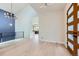 Bright foyer with hardwood floors, modern chandelier, and stylish wood door with modern design at 5820 Powell Rd, Parker, CO 80134