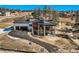 A modern house with a paved driveway and exterior stone accents at 5820 Powell Rd, Parker, CO 80134