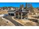 An elegant exterior view of a modern home with a paved driveway and well-maintained landscaping at 5820 Powell Rd, Parker, CO 80134