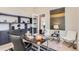 Modern home office with built-in shelving, a large desk, and comfortable seating at 5820 Powell Rd, Parker, CO 80134