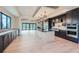 Well-appointed kitchen with black cabinetry, modern appliances, a spacious island, and hardwood floors at 5820 Powell Rd, Parker, CO 80134