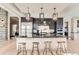 Modern kitchen features stainless steel appliances and a large island with seating at 5820 Powell Rd, Parker, CO 80134