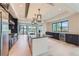 Modern kitchen with a large island, stainless steel appliances, custom cabinetry, and a sleek design at 5820 Powell Rd, Parker, CO 80134