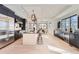 Sleek kitchen with dark cabinetry, stainless steel appliances, and large island at 5820 Powell Rd, Parker, CO 80134