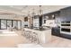 Open concept kitchen with island, stainless steel appliances, and a view into the living room at 5820 Powell Rd, Parker, CO 80134