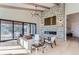 Bright living room with stone fireplace, hardwood floors, and access to deck at 5820 Powell Rd, Parker, CO 80134