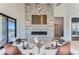 Spacious living area featuring a stunning stone fireplace and hardwood floors at 5820 Powell Rd, Parker, CO 80134