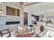 Open concept living space showcasing a fireplace and views into the kitchen at 5820 Powell Rd, Parker, CO 80134