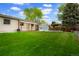 Sprawling backyard with gazebo, gardening boxes and well maintained lawn with access to back of house at 4994 S Independence Way, Littleton, CO 80123