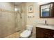 This bathroom showcases neutral tiling, a glass shower, a modern toilet, and a dark vanity at 4994 S Independence Way, Littleton, CO 80123