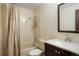 Bright bathroom featuring neutral tile, a shower-tub combo, and a dark vanity at 4994 S Independence Way, Littleton, CO 80123