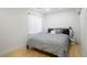 Bedroom with neutral walls, wood floor, a bright window, and gray bed set at 4994 S Independence Way, Littleton, CO 80123