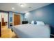 This bedroom features blue walls, wood floors, a closet, and a desk in the next room at 4994 S Independence Way, Littleton, CO 80123