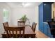 Cozy dining area with hardwood floors and natural light near to custom blue cabinets at 4994 S Independence Way, Littleton, CO 80123