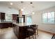 Kitchen island with granite countertop and pendant lighting is perfect for entertaining guests at 4994 S Independence Way, Littleton, CO 80123