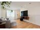 Bright living room featuring hardwood floors, a modern TV setup and comfortable furniture at 4994 S Independence Way, Littleton, CO 80123