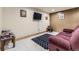 Finished basement area with TV, sofa, rug, and decorated walls at 17076 Foxton Dr, Parker, CO 80134