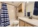 Bathroom featuring a vanity, framed mirror, shower/tub combo, and ceramic tile at 17076 Foxton Dr, Parker, CO 80134