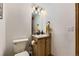 Cozy half bathroom with a vanity and modern lighting fixtures at 17076 Foxton Dr, Parker, CO 80134