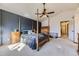 Spacious bedroom with a four-poster bed, ceiling fan, and access to an en-suite bathroom at 17076 Foxton Dr, Parker, CO 80134
