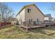 Exterior view of the home with a nice backyard, deck, and neutral siding on a sunny day at 17076 Foxton Dr, Parker, CO 80134