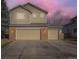 Two-story home showcasing three garage doors and a well-maintained driveway at 17076 Foxton Dr, Parker, CO 80134