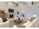 Bright living room features a cozy fireplace, ceiling fan, and neutral decor, creating a welcoming space at 17076 Foxton Dr, Parker, CO 80134
