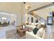 Airy living room with high ceilings, wood beams, and an open floor plan with lots of seating at 17076 Foxton Dr, Parker, CO 80134