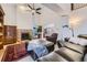 Bright living room with high ceilings, a cozy fireplace, and comfortable leather furniture at 17076 Foxton Dr, Parker, CO 80134