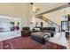 Open-concept living room with high ceilings, a staircase, and comfortable leather seating at 17076 Foxton Dr, Parker, CO 80134