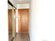 Hallway view of front door and mirrored closet with hardwood floors at 755 S Alton Way # 12C, Denver, CO 80247