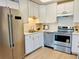 Bright kitchen featuring stainless steel appliances, white cabinetry, and ample countertop space at 755 S Alton Way # 12C, Denver, CO 80247