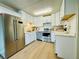 Bright kitchen featuring stainless steel appliances, white cabinetry, and ample countertop space at 755 S Alton Way # 12C, Denver, CO 80247
