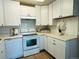 Bright kitchen featuring white cabinetry, sleek appliances, and light countertops at 755 S Alton Way # 12C, Denver, CO 80247