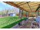 Spacious backyard featuring a covered patio and lush green lawn perfect for outdoor entertaining at 2561 S Carey Way, Denver, CO 80222