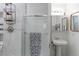 Modern bathroom featuring a glass enclosed shower, stylish fixtures, and a sleek pedestal sink at 2561 S Carey Way, Denver, CO 80222